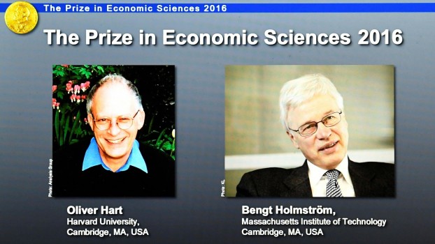 Winners of the Nobel Prize in Economic Sciences, economists Oliver Hart (left) and Bengt Holmstrom, are displayed on a screen at the Royal Swedish Academy of Sciences in Stockholm on Monday. Hart and Holmstrom won the Prize for their work on contract theory.